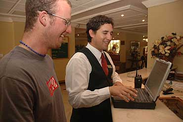 Niki and Marriott staff member work on Wally's Toughbook