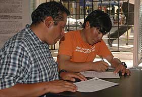 Oswaldo and Juancho complete their permit forms