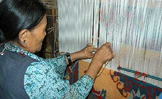 Skilled Tebetan woman creating carpets