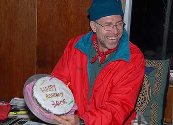 Steve holds up his chocolate birthday cake. Happy Birthday Steve!