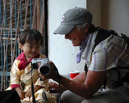 A child from Kathmandu smiles when she sees herself on Catharine’s camera