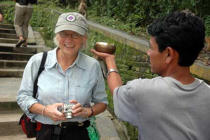 Wendy smils as she passes by a street merchant selling bowls