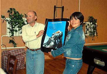 Wally presents Katarina with a signed Berg Adventures poster.