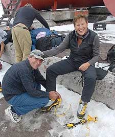 Lida getting help by Vladimir with her crampons