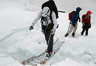 Brad Johnson crossing a crevasse on ladder