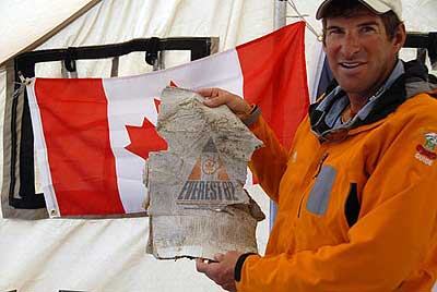 Dave Hahn holds up an old banner from the Canadian Everest 1982 expedition