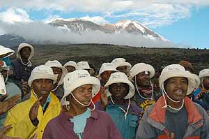 Chagga men singing with Kilimanjaro in the background.
