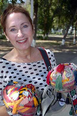 Linda takes a break from sightseeing to purchase some souvenirs from Uzbekistan