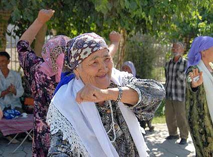 Dancing in the park after prayer- a group of Uzbek women share laughter in a park near the mosque