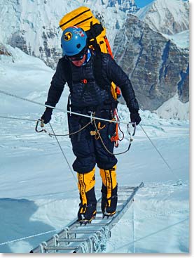 Daniel Branham crossing a ladder on Everest