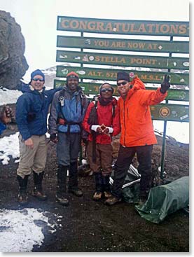 Danny and Hendrik with their guides Emmanuel and Samson on the top of Kilimanjaro