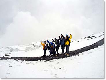 The team after reaching the summit, just as the snow is rolling in