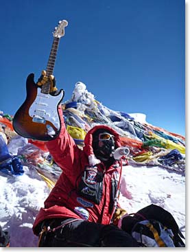 Todd Pendleton holds a signed Alice Cooper guitar on the Summit of Everest. He carried the guitar with him to raise money for the Leukemia and Lymphoma Society.
