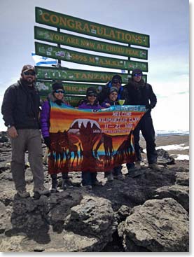 The Janmohamed family,  Josh Lannon and Jason Funk at Uhuru Peak, after dancing their way to the summit of Kilimanjaro!