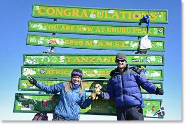 Brother and sister stand proud at Uhuru Peak, the Summit of Kilimanjaro 19,340ft