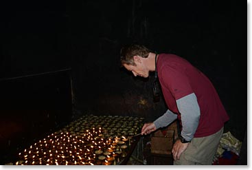 Climber lighting butter lamps in Kathmandu prior to his Everest climb