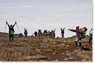 The Huffines team celebrates as they reach the crater rim