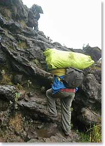 One of our porters carrying bags up the Barranco Wall