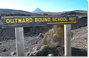 Old Outward Bound School Hut sign shows the group the way to go.