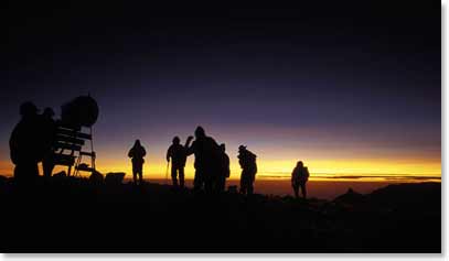A team climbs to the summit in the dark of night so they can see the spectacular sunrise from the top of Kilimanjaro.