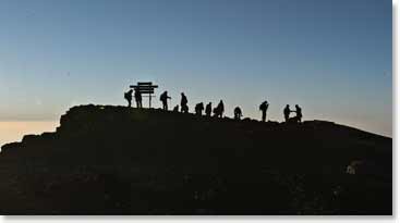 Night falls on the team as they watch the sunset from the summit of Kilimanjaro