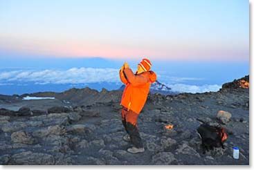 Howard, in a emotional moment, is taking a photo as he gets closer to his goal, the summit.