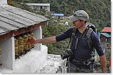 Jerome twirls the prayer wheels. The wheels depict Tibetan Buddhist prayers, mantras and symbols. According to tradition, spinning the wheel is similar to reciting the prayers outloud