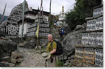 Mitchell walks clockwise around the Mani Walls. Mani Walls are made up of stones that are placed together along the trail and are offerings to the deceased