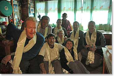 Group gathers around Lama Geshe and display their katas or white scarves