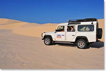 Our land rover roars over the sandy dunes