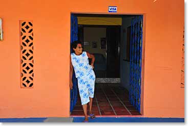 A local women stands outside of her restaurant in the village of Maze