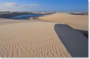 The simple patterns and colors of the sand and water are beautiful