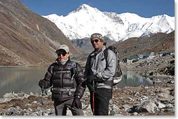 Giant snow capped peaks tower over Leland and Michael as they arrive in Gokyo