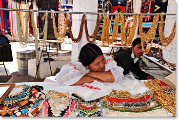 Sunday is usually a day of rest and is pretty quiet in Ecuador. A local woman enjoys the afternoon while taking a nap at her stall