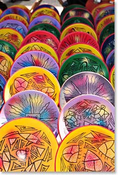 Rows of hand-painted plates for sale at the market