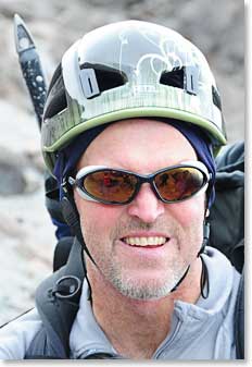 Richard gets his helmet on, puts his ice axe in his pack and sets off to climb Cayambe