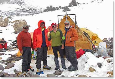 Osvaldo joins the boys for a warm drink at High Camp