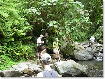 Julia and Greg show their hiking skills as they jump the creek