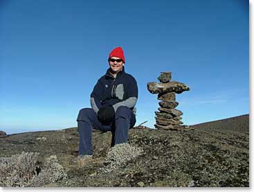John takes a break by a cairn that marks the trail up