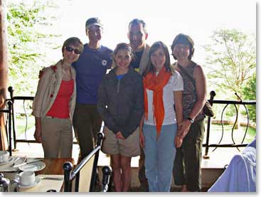 The group enjoys their last breakfast together. They enjoyed their meal as they watch 5 giraffes in the garden outside