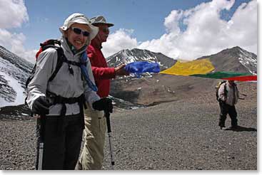 Jim and Janet hold prayer flags as they take a look at the fantastic scenery surrounding them