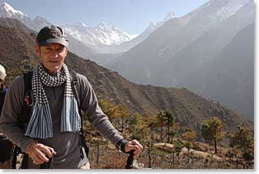 Ed walks to the overlook with Everest, Lhotse and Ama Dablam behind