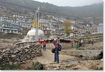 Nuru motions the group onward as they arrive in Namche