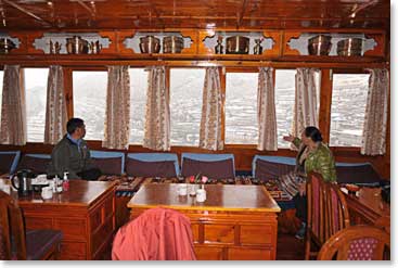 Temba and Lakpa Doma survey a white Namche from the window of Panaroma Lodge