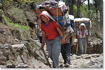 When we finally hit the trail we remembered that is was Thursday; we saw strings of porters, men and women, heading for the Saturday Namche Market