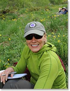 Carol sitting in the meadow catching up on her journal entries