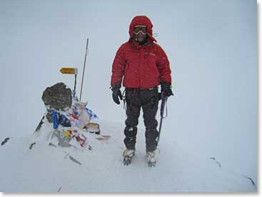 John Bank stands by the summit rock