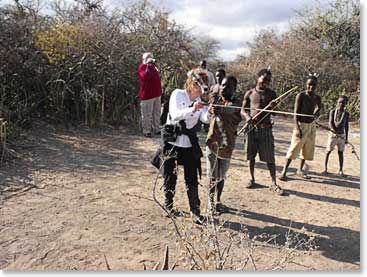Marjorie getting a lesson with the bow and arrows