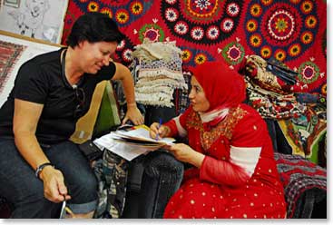 Annette and Zainab work on the shipping details to get her carpets back to Australia.