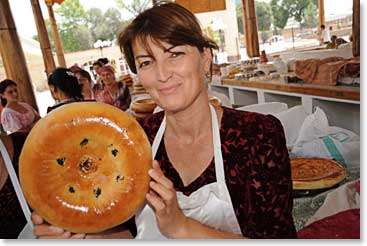 Women in the market display their daily loaves of fresh bread with pride.